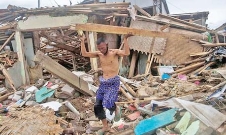 A man salvages wood after the earthquake that struck Cianjur, in West Java province.