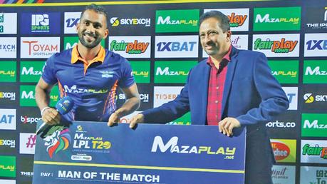 Kandy Falcons all rounder Chamika Karunaratne receiving the Player of the Match award from the Assistant Treasurer of SLC Sujeewa Godaliyadda at Pallekele. (Pic by Nathan Shanmuganathan)