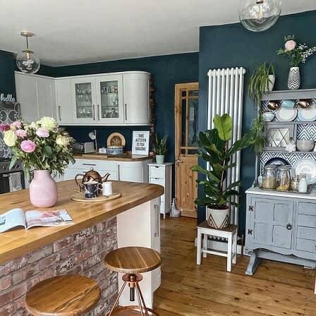 a tall white vertical column radiator in a country style kitchen