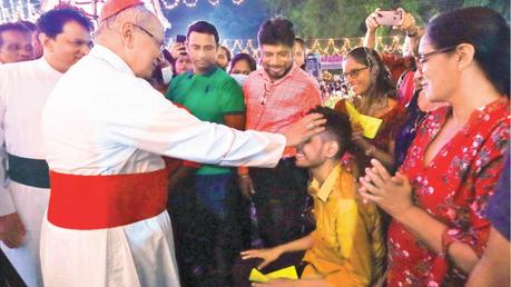 Archbishop of Colombo His Eminence Malcolm Cardinal Ranjith who officiated at Christmas Midnight Mass at Christ the King Church, Pannipitiya seen blessing a youth. Picture by Sulochana Gamage