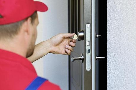 A locksmith opens the door of the house