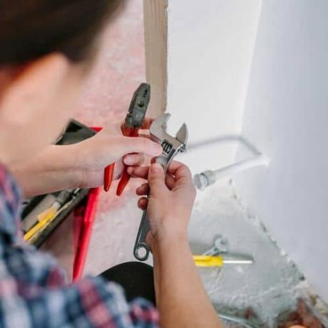 woman holding a spanner