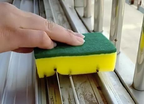 Cleaning window rails with a sponge