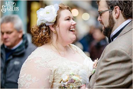 Bride and groom smile on the streets of York wedding
