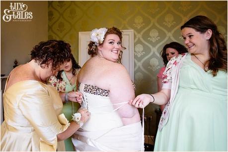 Beautiful plus sized bride has corst laced at work wedding
