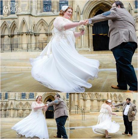 Bride and groom dance out front of the minster at Wedding