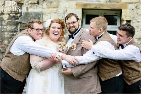 Groomsmen give big group hug at York wedding 