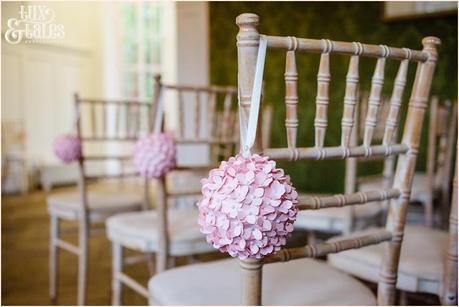 Pink flower ball detail on wedding chair York Grays Court