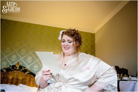 Beautiful stylish plus sized bride cries at grooms letter at York wedding