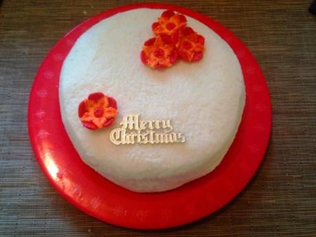 easy alternative christmas cake recipe tropical fruit mango pineapple papaya with apricot rum and ginger red and orange flower fondant decoration coconut icing
