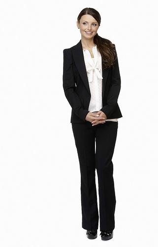 Happy young business woman against white background