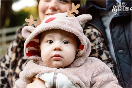 Cute baby in reindeer costume 