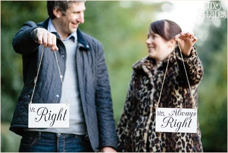 Cute engagement shoot poses couple holding signs 