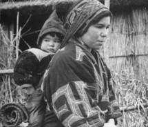 Ainu woman and baby in traditional garb,.