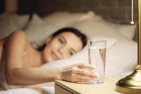 Drink a glass of water placed on the bedside table
