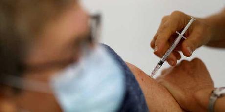 A nurse administers a COVID-19 vaccine to a patient at a vaccination center in November 2021.