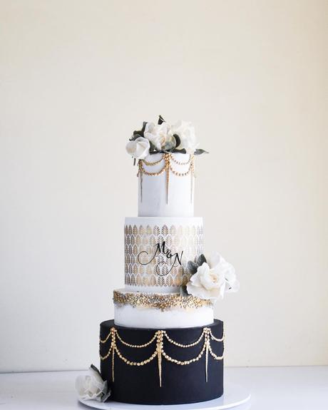 black and gold cakes with white three layeres