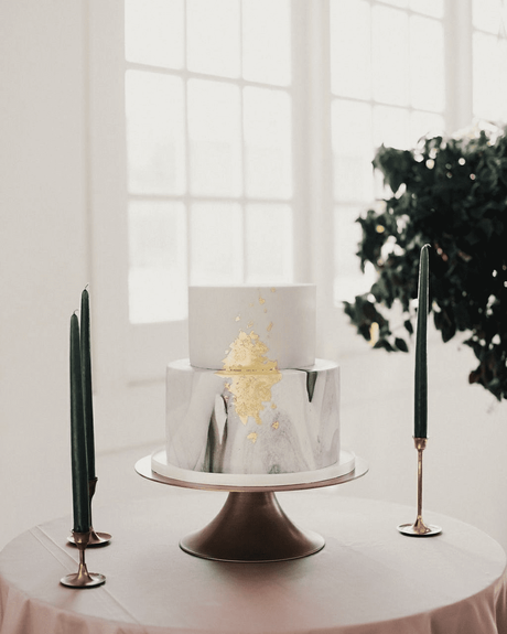 black and gold cakes with white two layeres