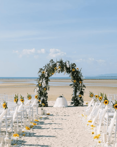 beach wedding ceremony arch with greenery