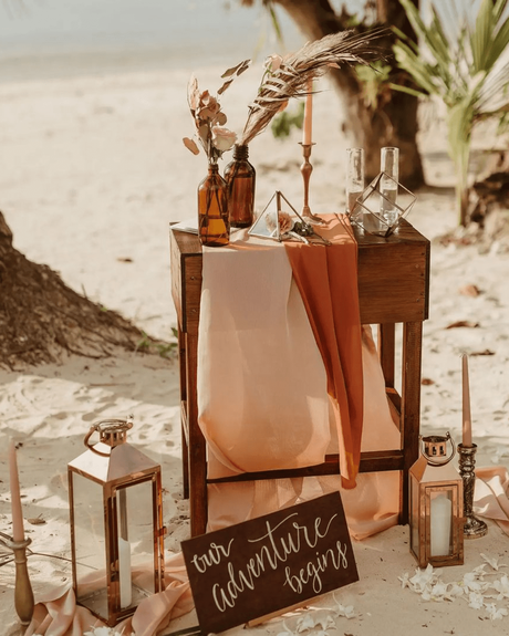beach wedding decor with candles bottles and vintage table