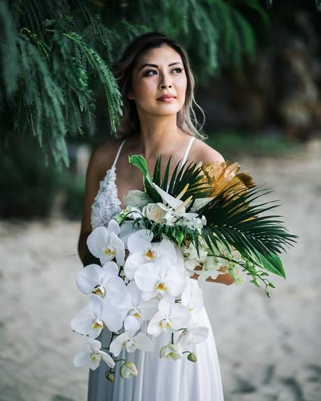 beach wedding bride holding white bouquet