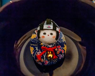 A cute little object – a pincushion perhaps? – posed in several settings