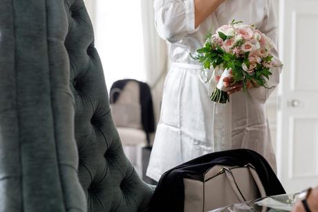 bride holding her bouquet in her dressing gown
