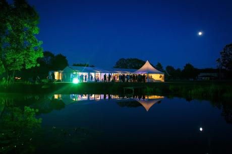 wedding marquee at night reflected in the lake
