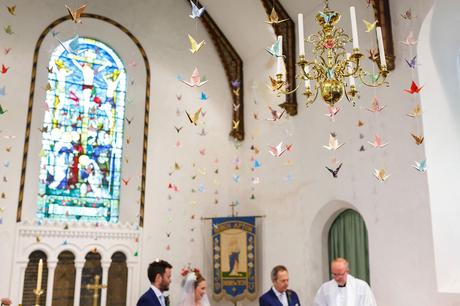 Senbazuru origami cranes hang in church