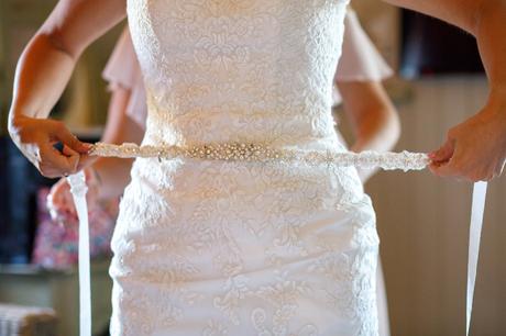 a bride fixes her belt