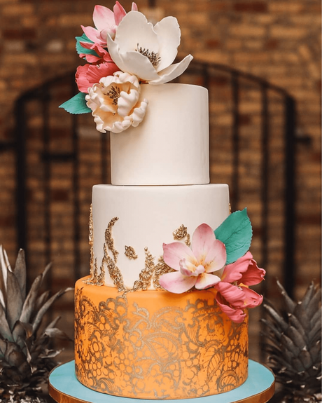 tropical wedding cakes three layers in orange and blush with flowers