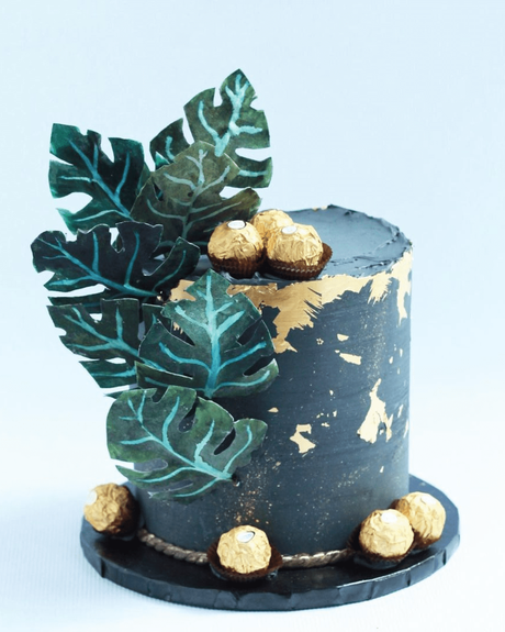 tropical wedding cakes with banana leaves in dark