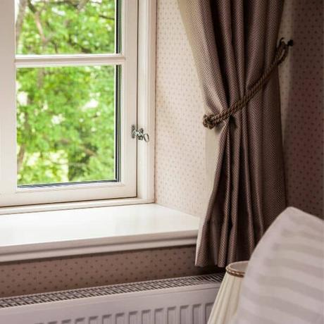 short curtains hanging over a radiator