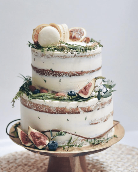 naked wedding cakes with macaron and flower decor