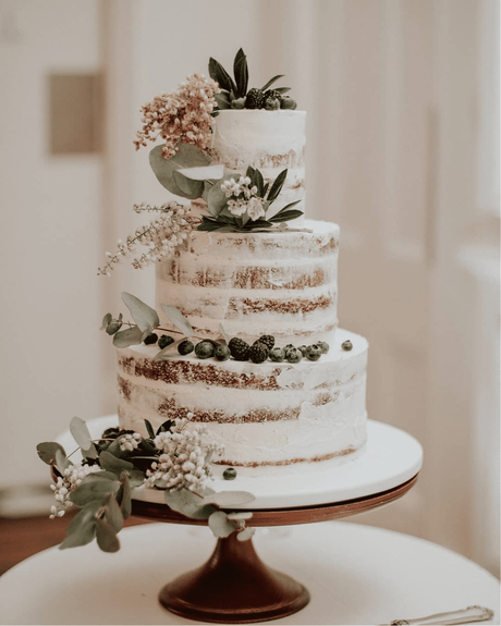 naked wedding cakes with floral decor