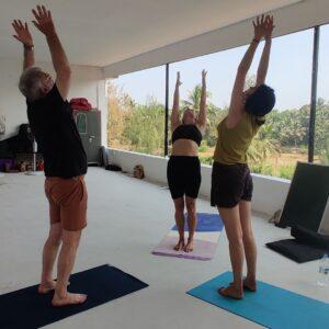 Students-are-performing-Hastauttanasana-Raised-Arms-Pose-at-Diya-Yoga
