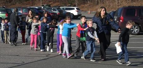 In this Friday, Dec. 14, 2012 file photo provided by the Newtown Bee, Connecticut State Police lead a line of children from the Sandy Hook Elementary School in Newtown, Conn. after a shooting at the school. (AP Photo/Newtown Bee, Shannon Hicks)