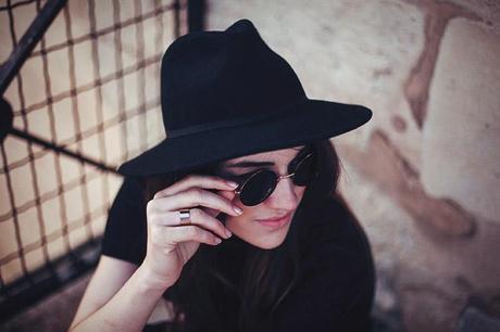 gold and black sunglasses with fedora hat and gold ring