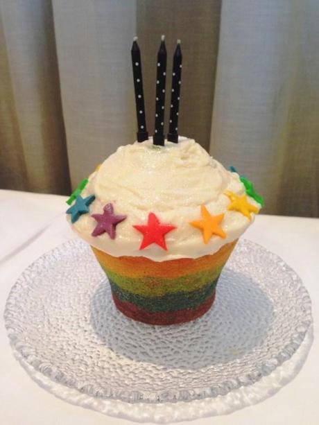 rainbow birthday cake with candles all in one giant cupcake recipe with buttercream topping and fondant stars