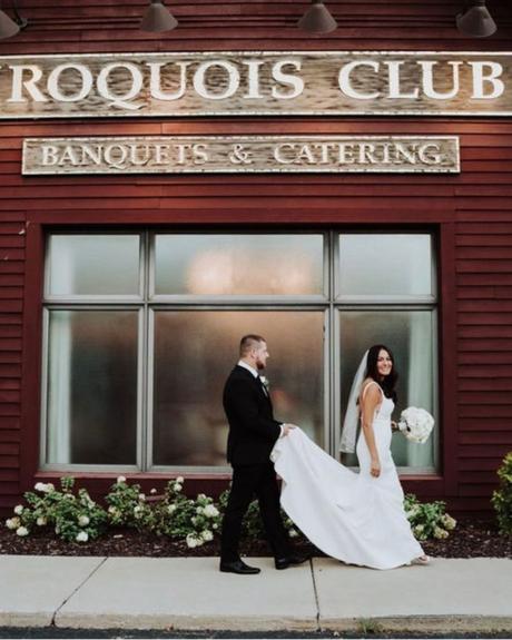 best wedding venues in michigan groom holds parting the bride dress