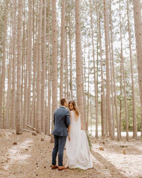 best wedding venues in michigan bride with groom in the pine forest