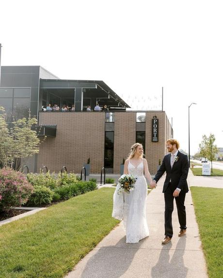 best wedding venues in michigan groom and bride walking hand in hand