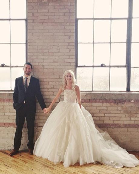 best wedding venues in michigan groom with bride by the brick wall