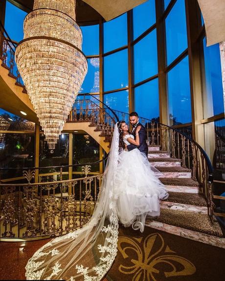best wedding venues on long island brides standing on the stairs by the crystal chandelier