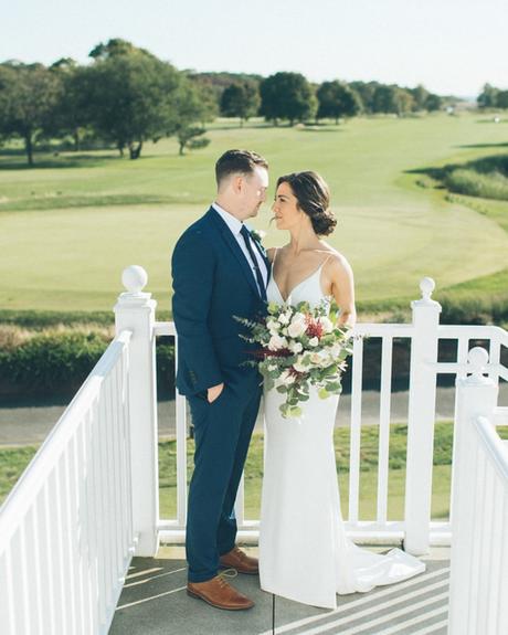 best wedding venues on long island brides standing on white stairs overlooking a green field
