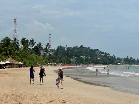 people-walking-on-mirissa-beach-sri-lanka