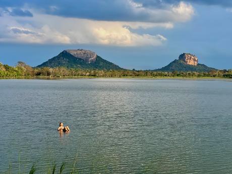 swimming-in-a-lake-near-sigiriya-with-pidurangala-and-lions-rock-in-the-background