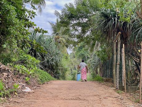 woman-with-long-pink-skirt-walking-down-hiriketiya-beach-road