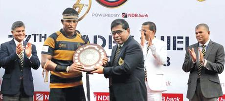 Feroze Suhayb, former Royal center and Chief Guest, handing over the Bradby Shield to Royal Skipper Randul Senanayake in the presence of  Sriyan Cooray (1983 Royal Captain), R. M. M. Rathnayake (Principal, Royal) and M. A. M. Riyaz (Senior Games Master, Royal) 