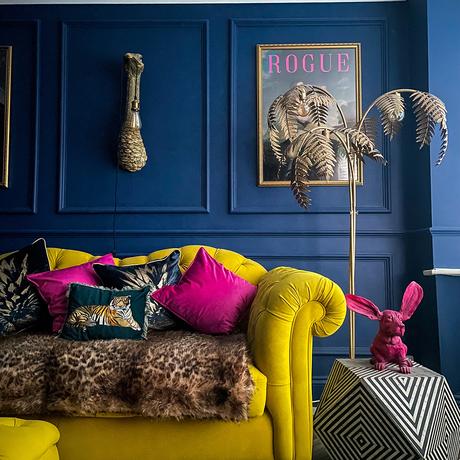 Navy blue living room with wall panelling and yellow velvet sofa. Featuring our Leopard Print Super Soft Faux Fur Throw. Image by @fancylittle15